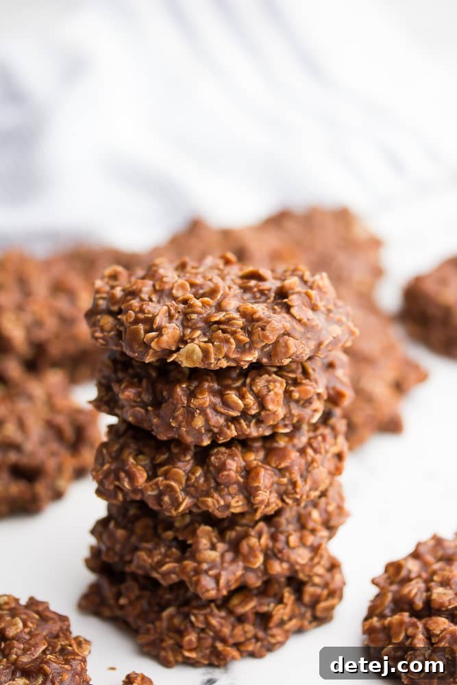 5 brown cookies stacked on top of each other, showing off their perfect shape.