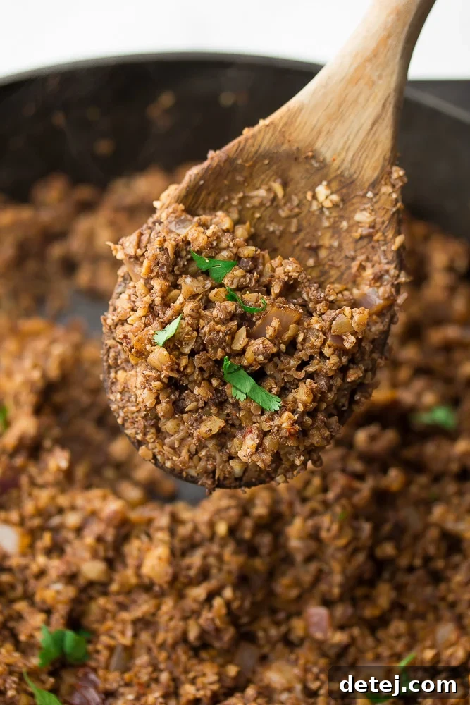 The Ultimate Vegan Taco Filling 5 wooden spoon holding taco meat over a pan