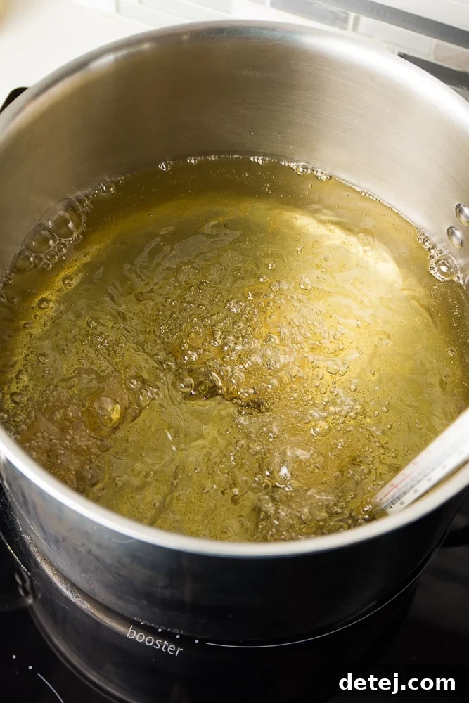 vegan cheese sticks frying in hot oil in a large pot