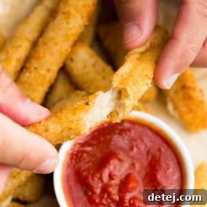 square image of fried cheese being pulled apart with hands