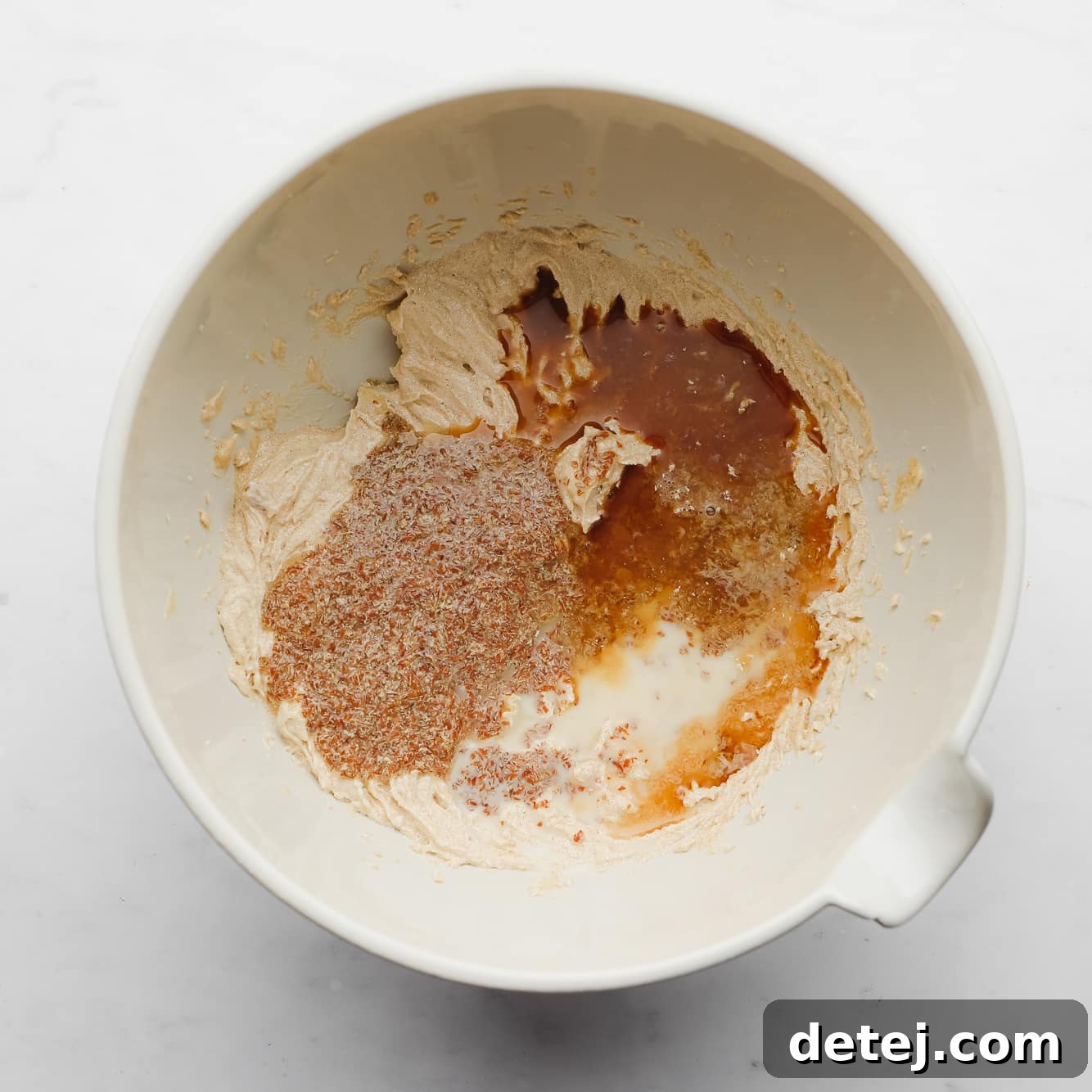 wet cookie dough ingredients mixed together in a large white bowl.