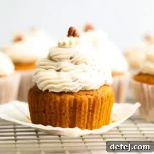 square image of close up cupcake from the side with pecans on top