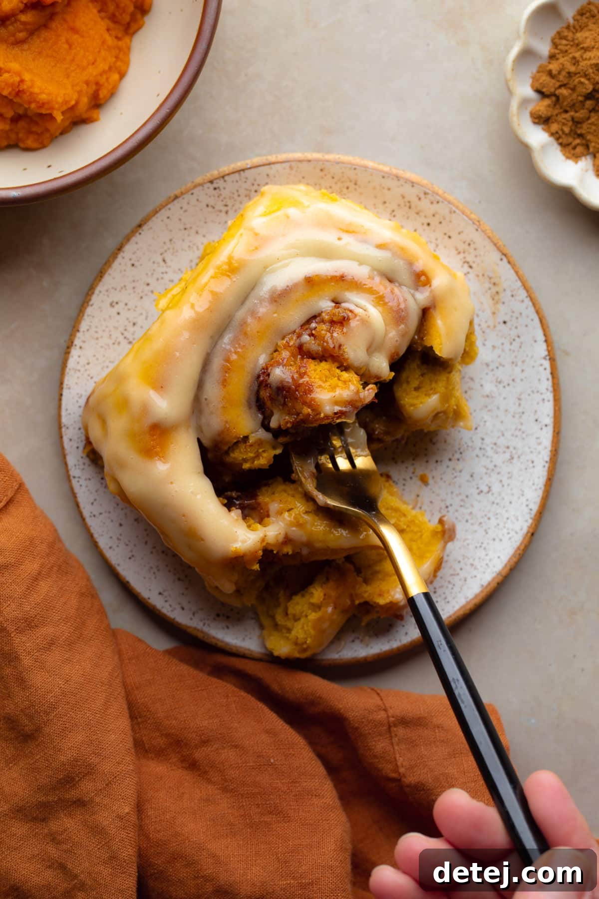 fork taking bite of pumpkin cinnamon rolls