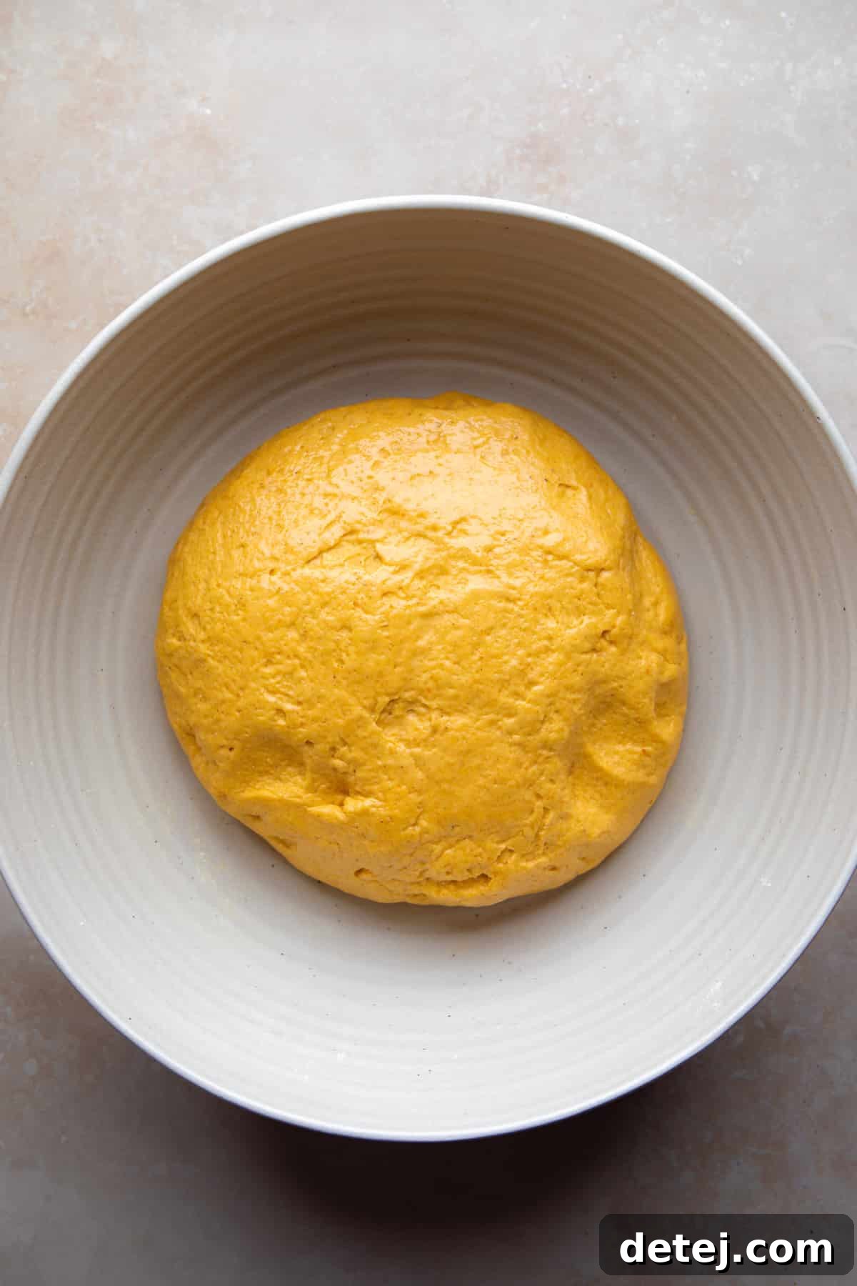 cinnamon roll dough in bowl before rising