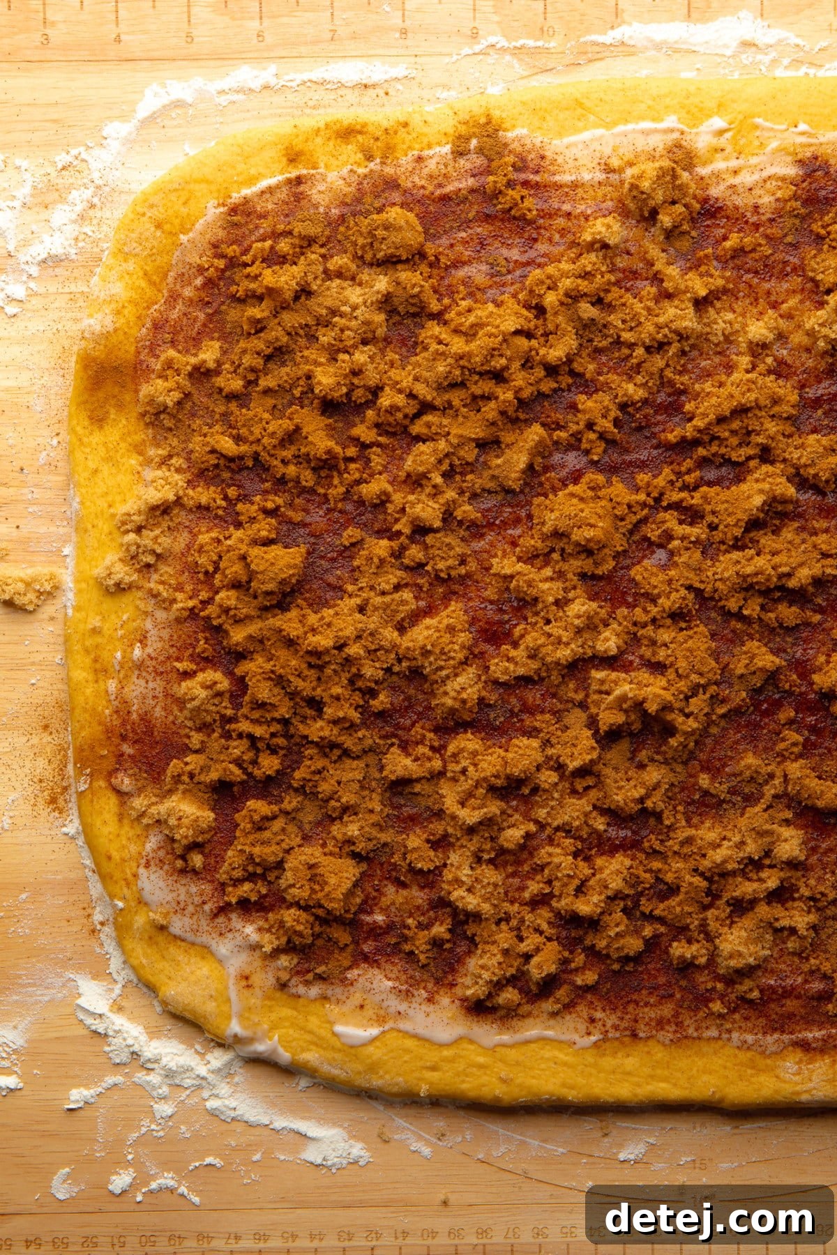 cinnamon and brown sugar on cinnamon roll dough