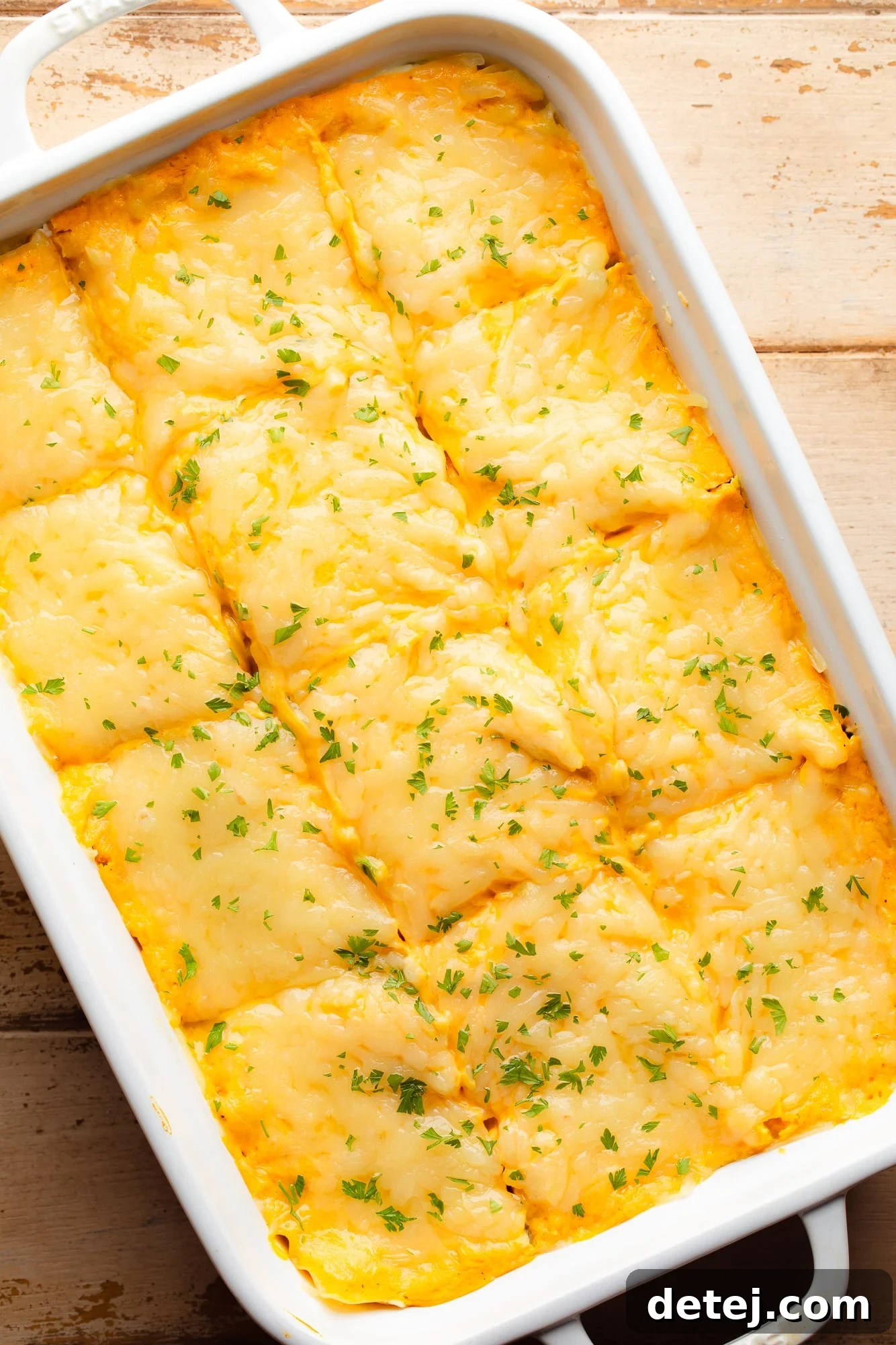 Overhead view of a baked and sliced vegan butternut squash lasagna in a casserole dish, ready to be served.