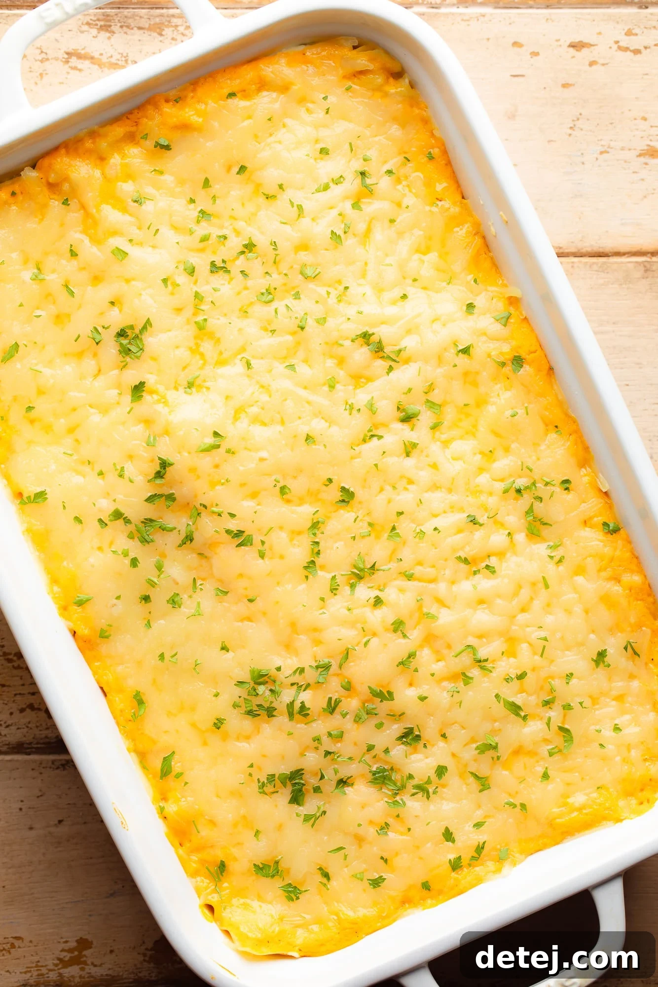 Overhead view of a perfectly baked vegan butternut squash lasagna, golden brown and bubbly, in a casserole dish.
