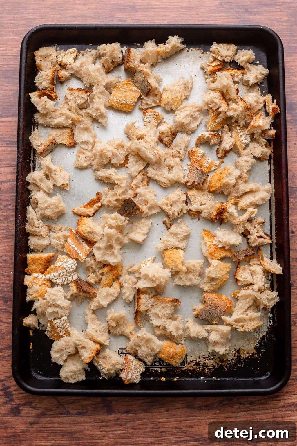 Ultimate Vegan Stuffing 5 Dried bread cubes spread out on a baking sheet, ready for stuffing.