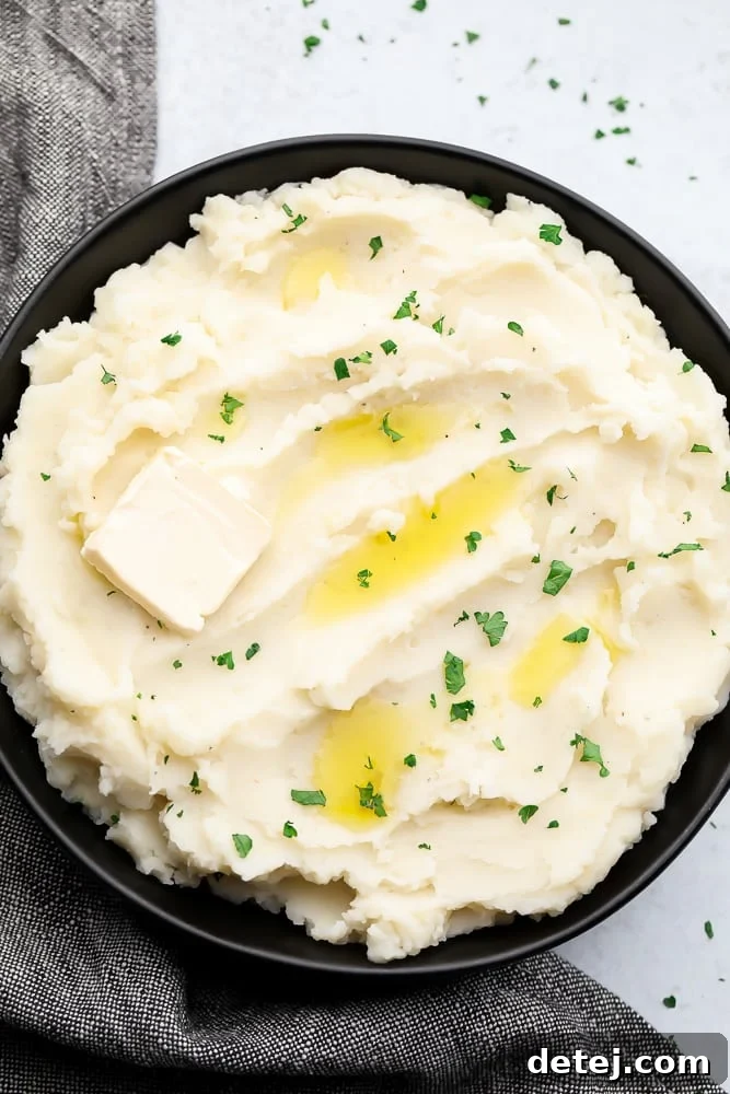 black bowl full of mashed potatoes with butter