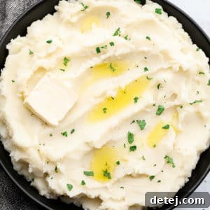 square image of mashed potatoes in black bowl