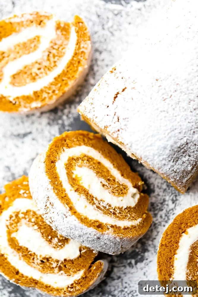 A beautifully presented vegan pumpkin roll, partially sliced, dusted with powdered sugar, ready to be served on a rustic background.