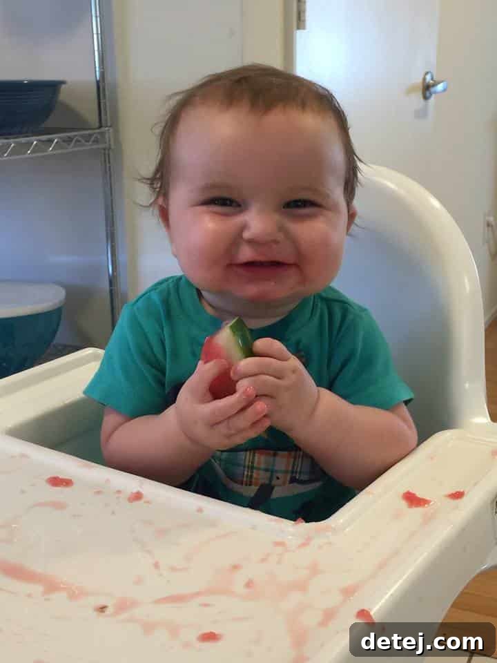 baby holding watermelon