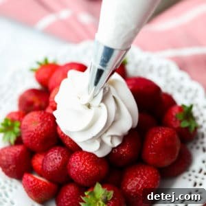 A captivating Pinterest image featuring delicious coconut whipped cream, overlaid with text highlighting its dairy-free and fluffy nature.