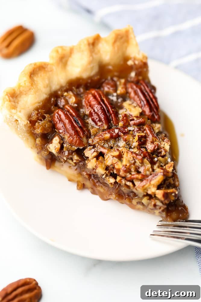 A delicious slice of vegan pecan pie on a white plate