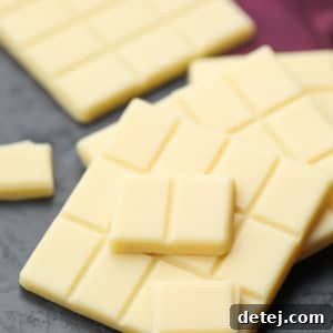Square image of white chocolate, with a burgundy towel in the background, showcasing its delicious appeal.