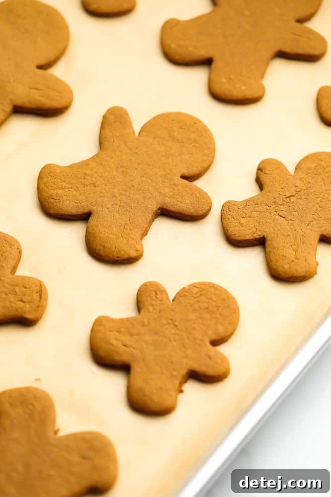 A festive tray filled with freshly baked vegan gingerbread cookies, adorned with simple white icing.