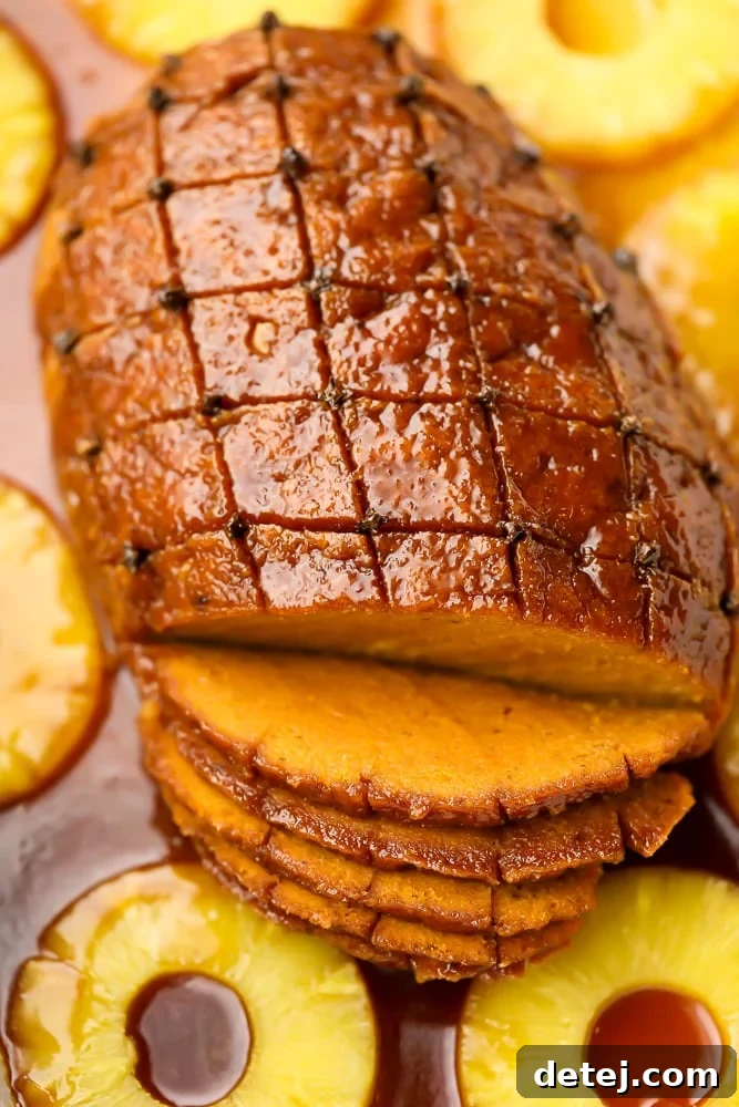 A stunning vegan ham roast in a baking dish, beautifully glazed and ready to serve for a festive meal.