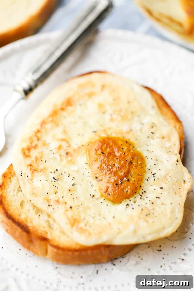 Vegan fried egg on a piece of toast with a fork, ready to be enjoyed