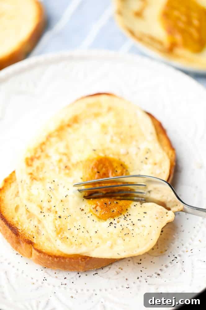 A fork cutting a vegan egg on toast, showing the texture of the white and yolk