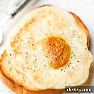 Square image of a vegan fried egg on toast, representing the finished dish