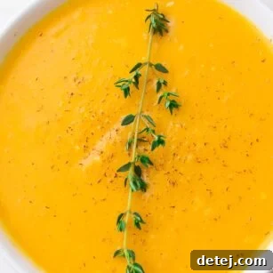 close up of a bowl of instant pot butternut squash soup with thyme