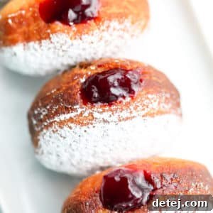 Square image of delicious vegan jelly filled donuts, ready to be enjoyed.