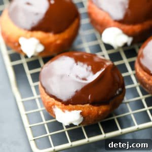 square image of boston cream donuts on rack