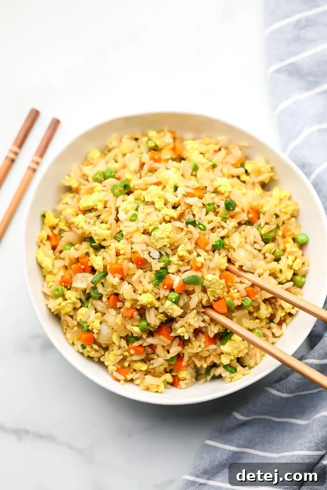 bowl of fried rice with chopsticks, white background