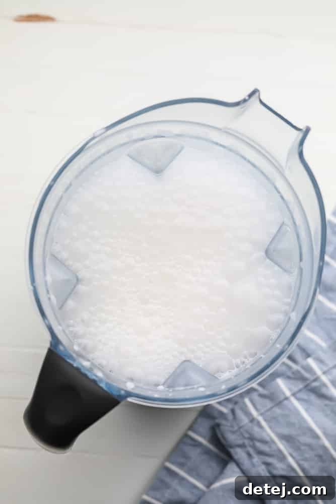 blender full of bubbly white liquid