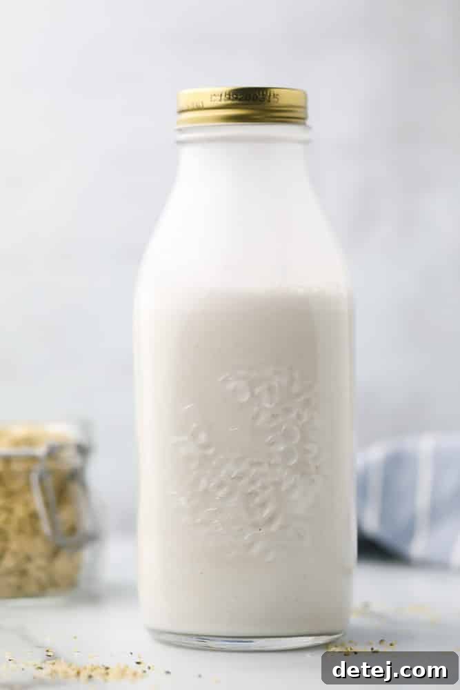 Large jar of homemade hemp milk with a sprinkle of hemp seeds on a grey background