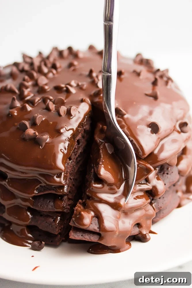 fork taking a bit from a stack of chocolate pancakes