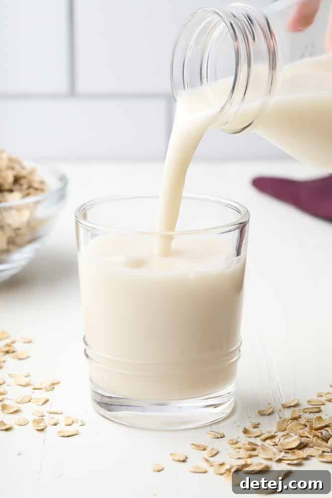 Freshly poured homemade oat milk in a glass, ready to be enjoyed.