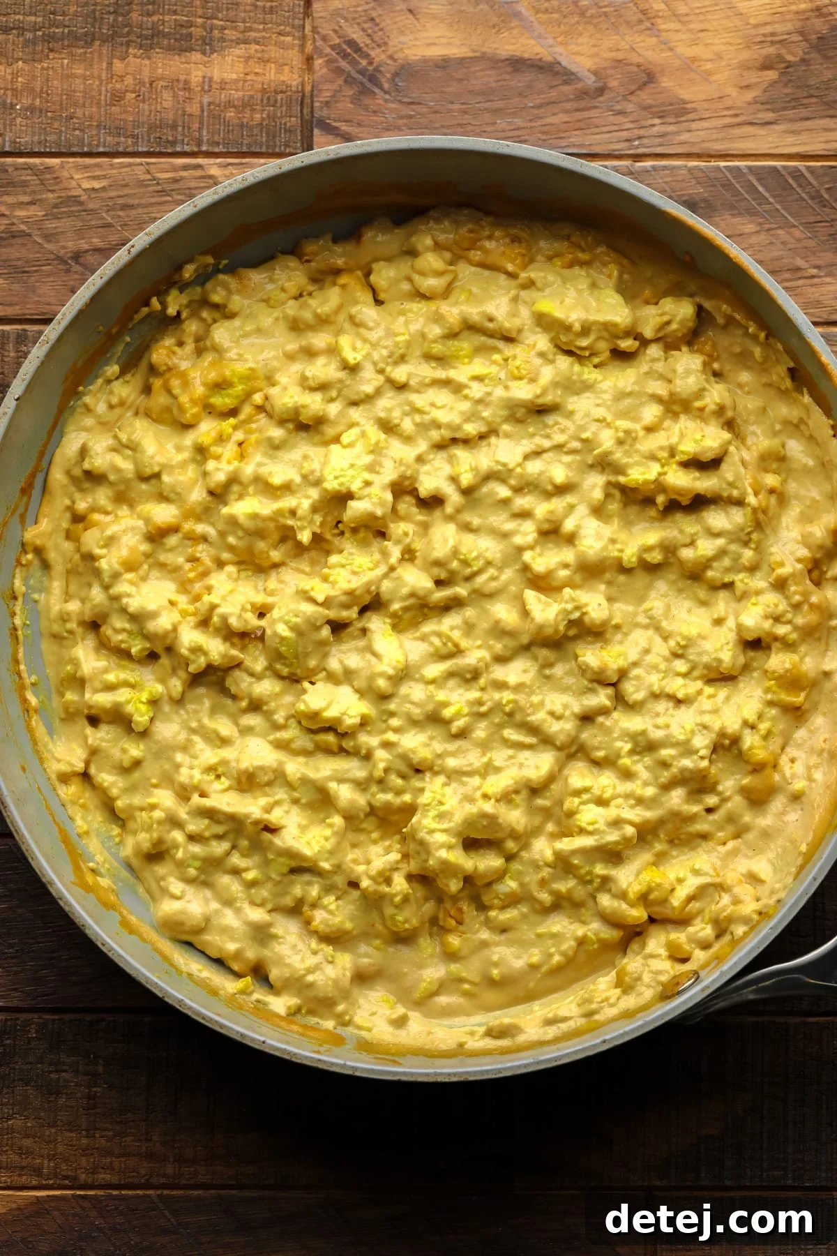 egg looking yellow mixture in pan on wood board