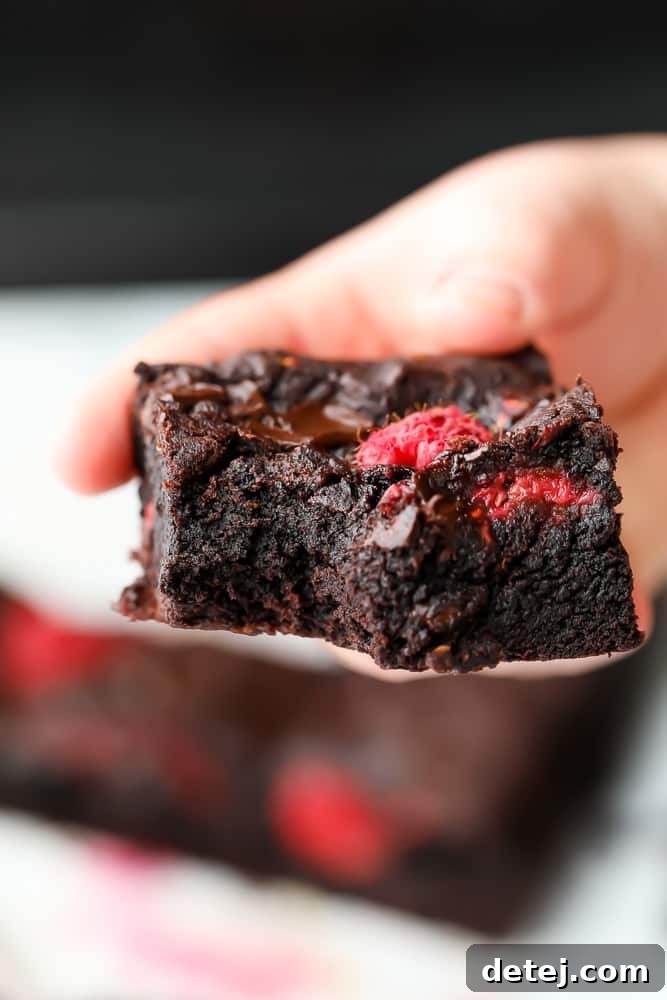 a bite taken out of a brownie with fruit in it