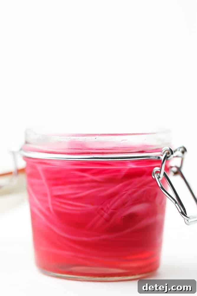 Tangy Ruby Onions 5 sliced red onions in a sealed mason jar