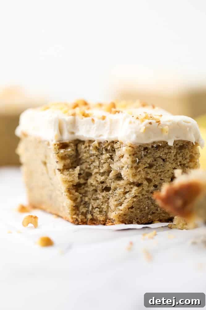 A close-up of a slice of vegan banana cake on a plate, revealing its beautifully fluffy and light texture, indicating a well-baked and moist cake.
