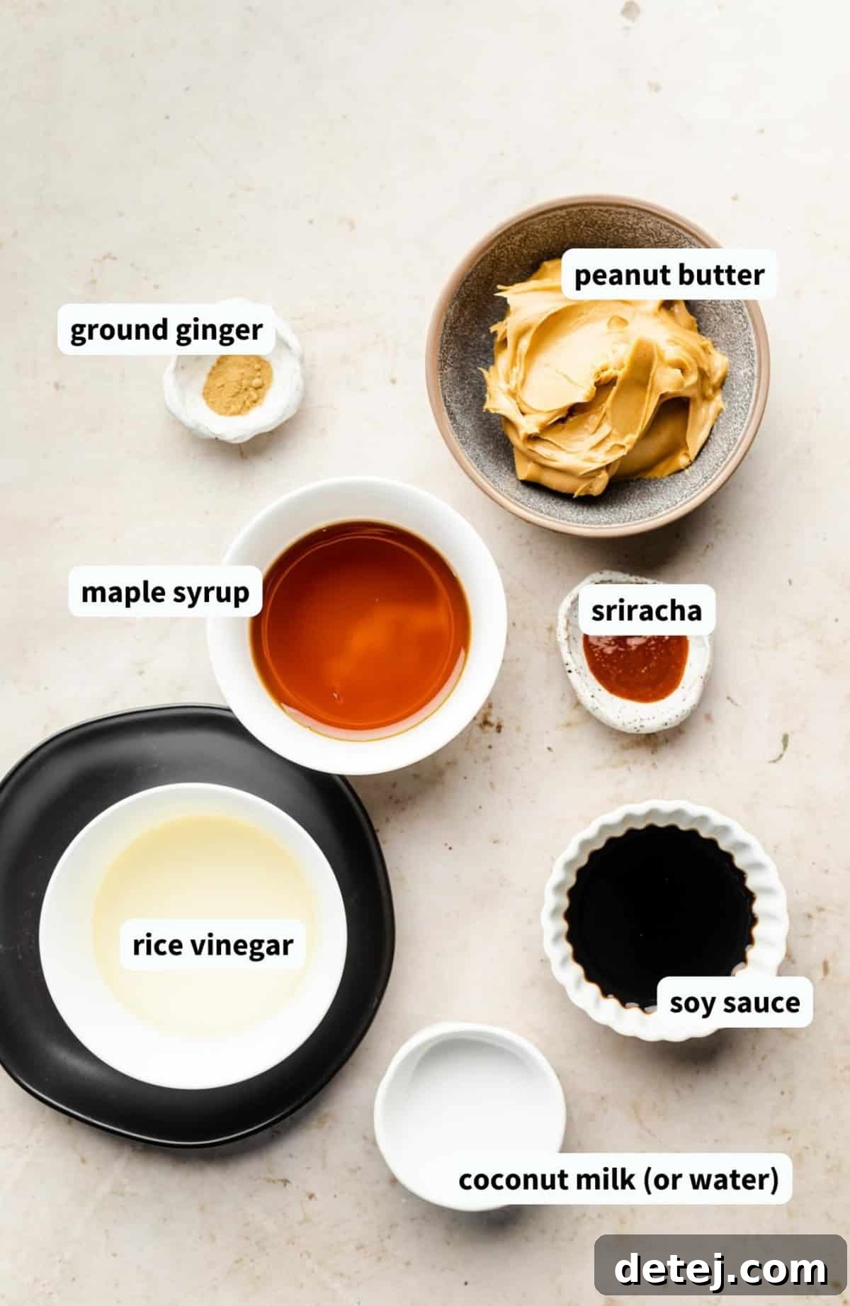 Individual white bowls showcasing all the fresh and simple ingredients required for making homemade vegan peanut sauce.