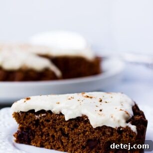 Round Oil-free Chocolate Cake with Cashew Frosting, garnished and ready to serve