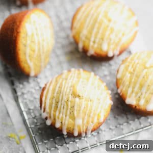 square image of lemon muffins with glaze on cooling rack