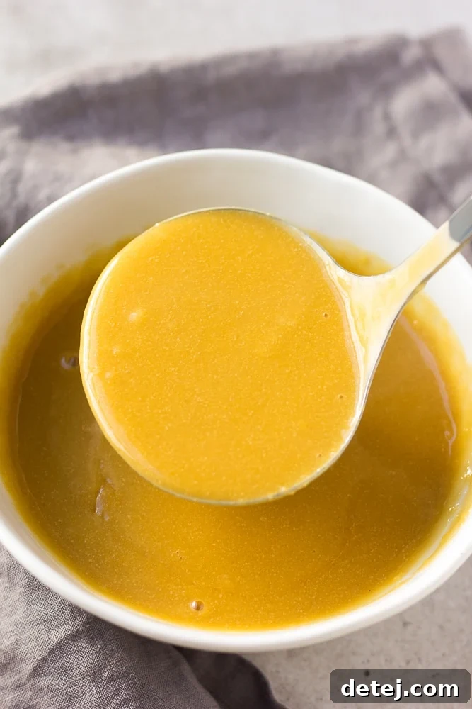 a ladle scooping easy vegan gravy from a pot