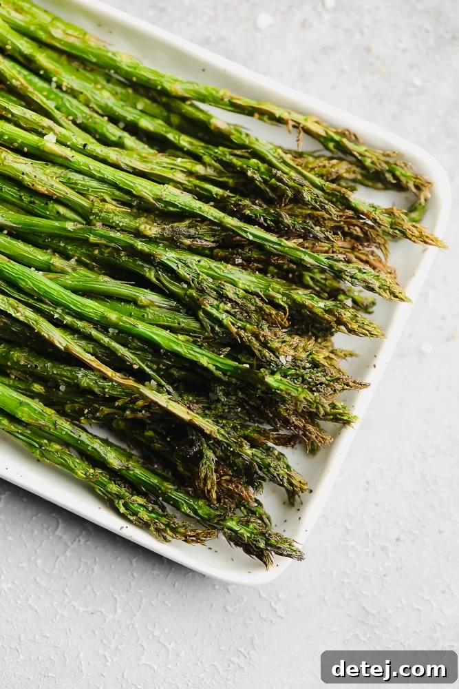 cooked asparagus on a white serving plate