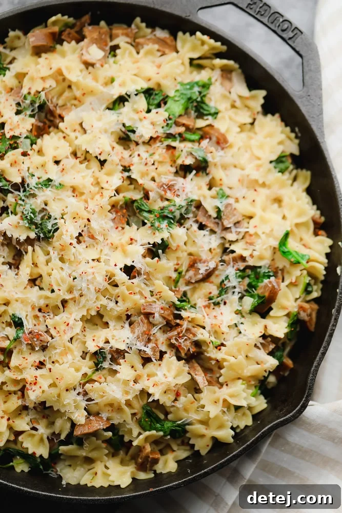 close up of vegan sausage pasta in black pan
