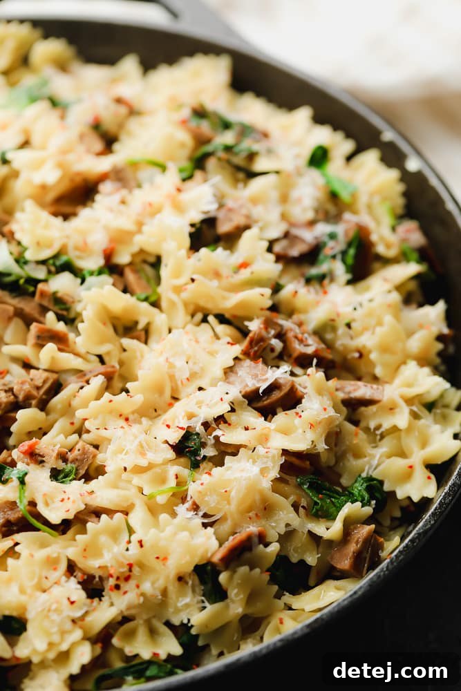 a cast iron pan full of pasta and sausage