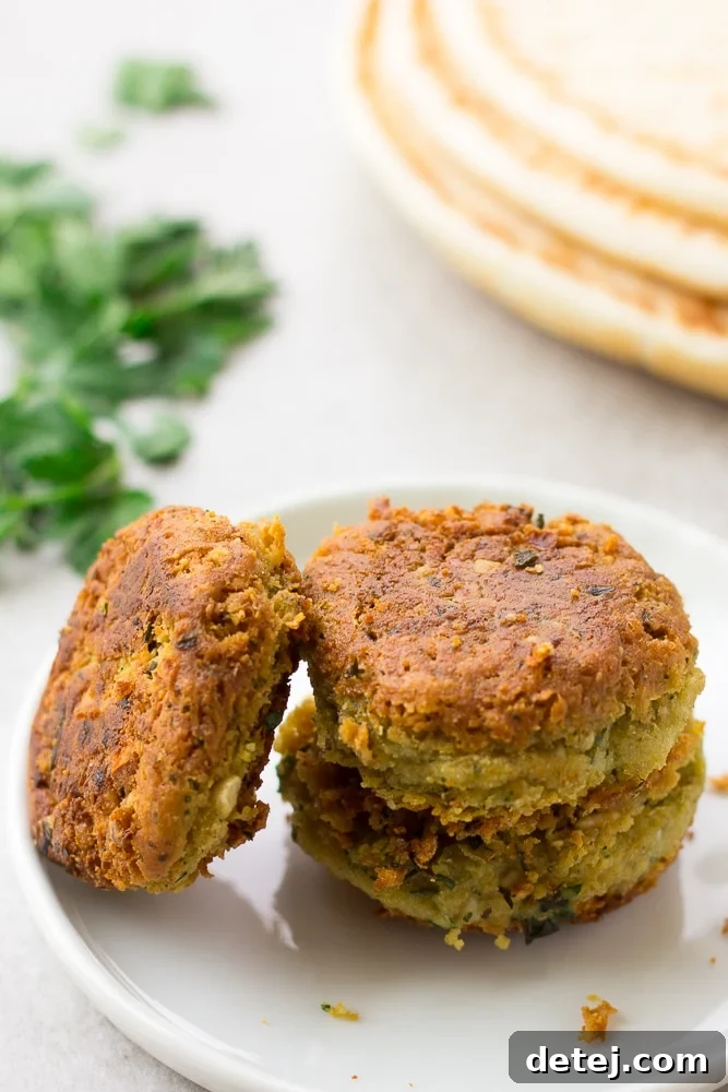 Three perfectly cooked vegan falafel patties resting on a plate, showcasing their inviting texture