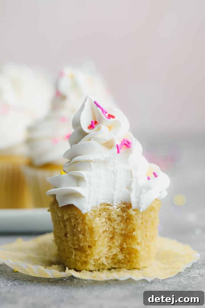 cupcake with a bite taken out of it, showing frosting texture