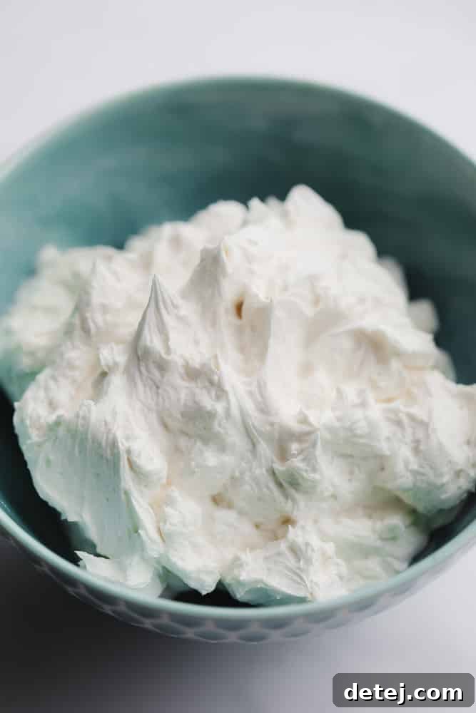 teal bowl with white frosting in it