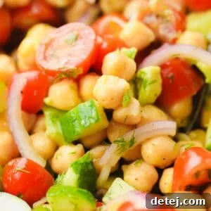 close up on a chickpea salad with tomatoes and cucumbers