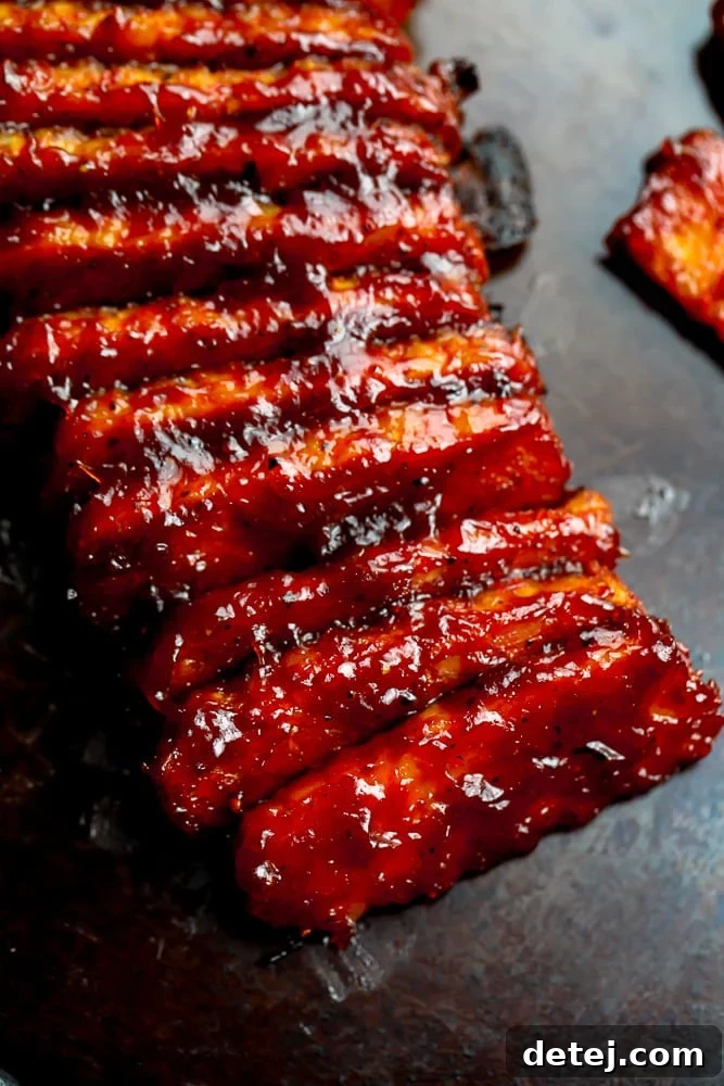 Delicious sticky vegan ribs on a baking sheet, ready for a backyard barbecue