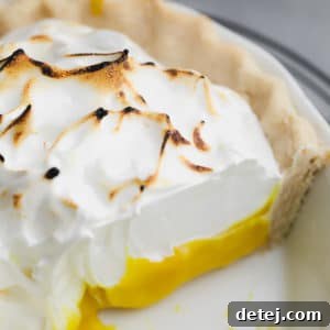close up on a lemon meringue pie with a slice removed