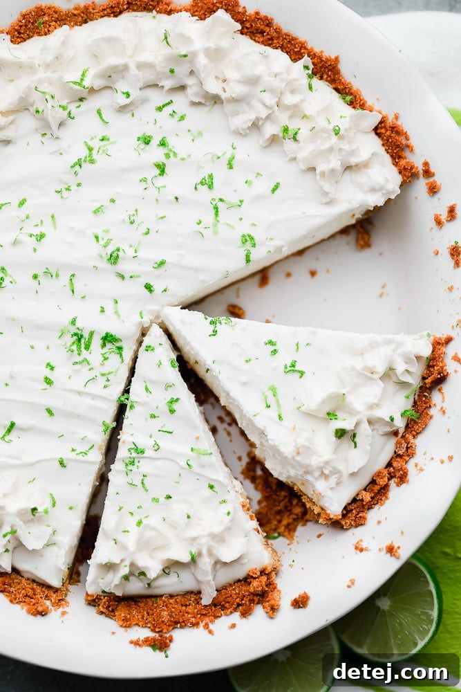cut slices of key lime pie in a white pie plate